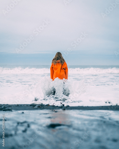 girl in raincoat near ocean 