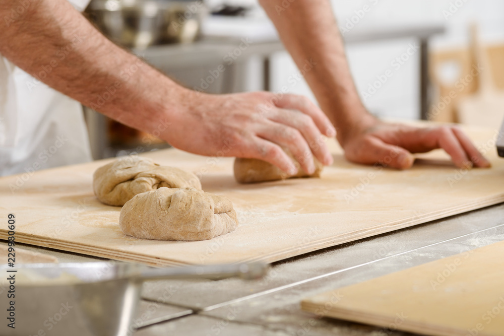 Baker is kneading dough