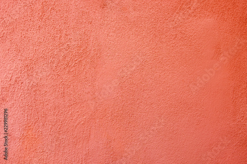 Old red whitewashed wall with rich and various texture.