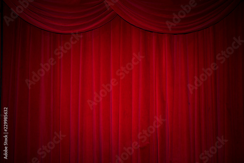 Large red curtain stage  with spot lights and dark background