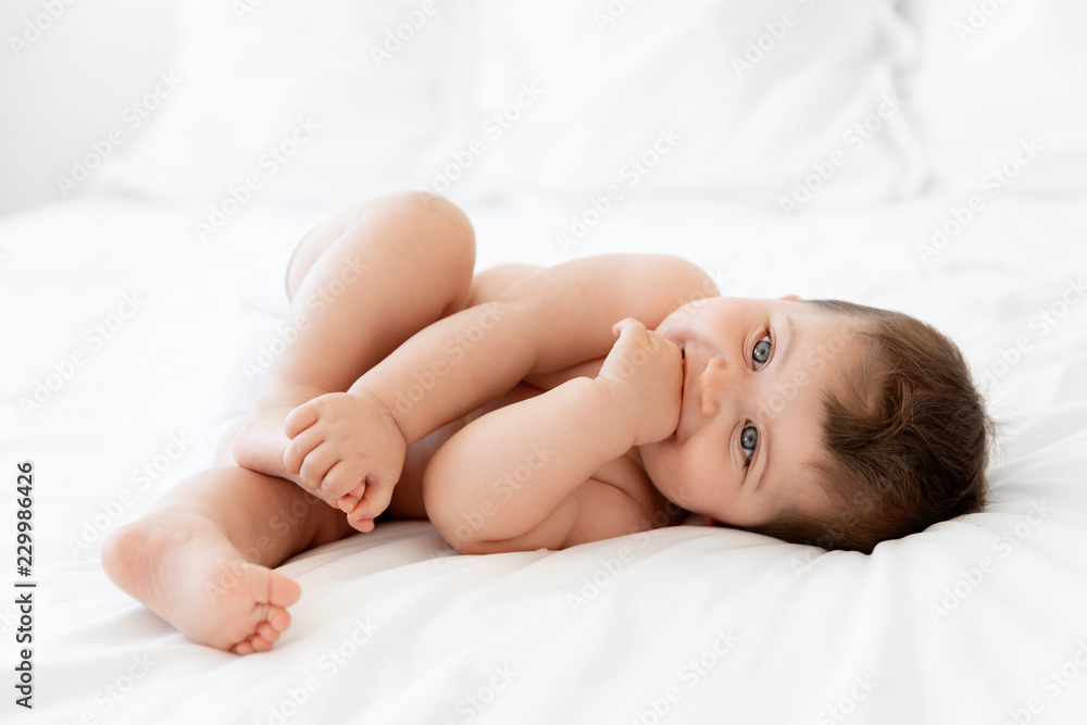 Cute chubby baby on white bed Cute chubby baby on white bed