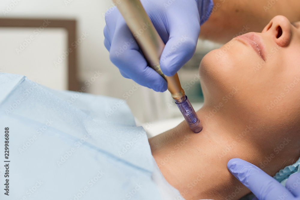Later view of a woman reiving microdermabrasiation on the neck Later view of a woman reiving microdermabrasiation on the neck