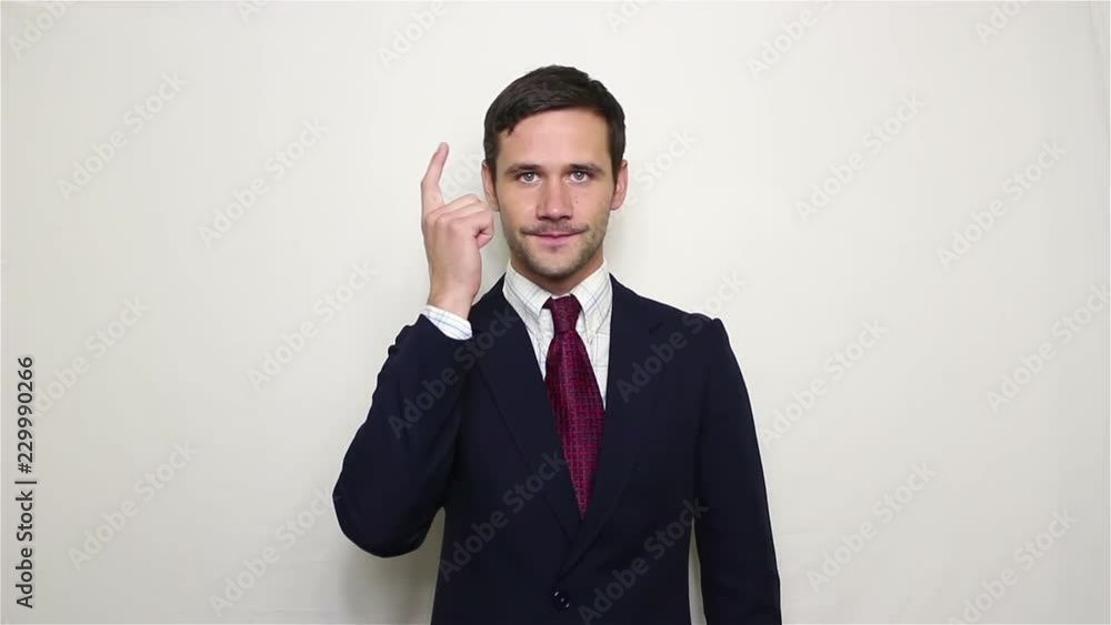 Handsome young businessman pounding his finger on the head urging to think carefully.Portrait on a white background. Handsome young businessman pounding his finger on the head urging to think carefully.Portrait on a white background.