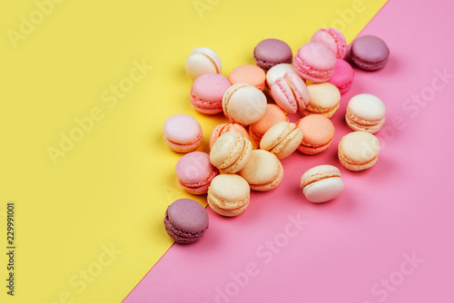 macarons on yellow - pink background divided diagonally into two triangles