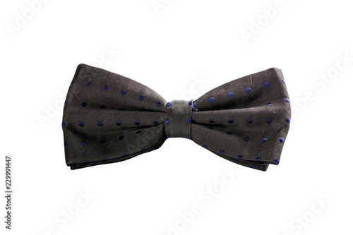 Black bow tie with blue spots isolated on white background photo