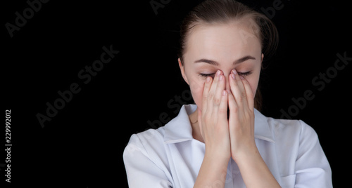 Wallpaper Mural Front view of a young intellectual doctor on a black background with text space. The medical worker has a headache Torontodigital.ca
