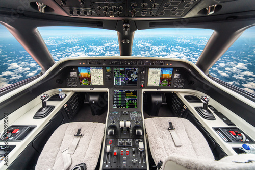 Closeup high detailed view of aircraft control unit in the cockpit of modern civil passenger airplane flying high