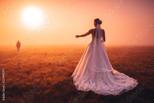 Wedding vivid photo. Bride take a hand to groom in autumn morning nature