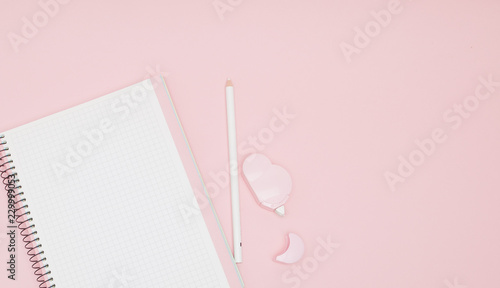 Notebook, white sheet, pencil, proofreader. Pink background.Instagram concept