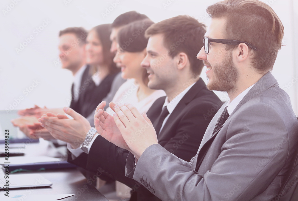 Fototapeta premium cheering business team sitting at Desk