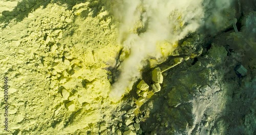 Aerial view of crater Ijen volcano with evaporation of sulfur dioxide gas where sulfur is mined. 4K