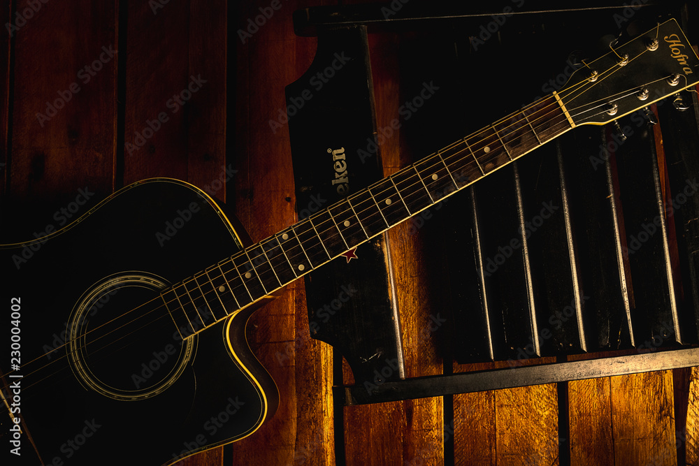 Fototapeta premium acoustic guitar and a chair