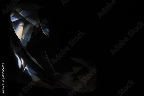 Diamond elements close-up on a black background. Abstraction. Defocused.