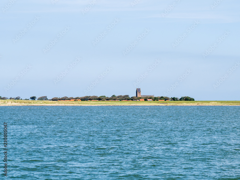 View of church of Hollum and coast of Ameland island in Waddensea, Friesland, Netherlands