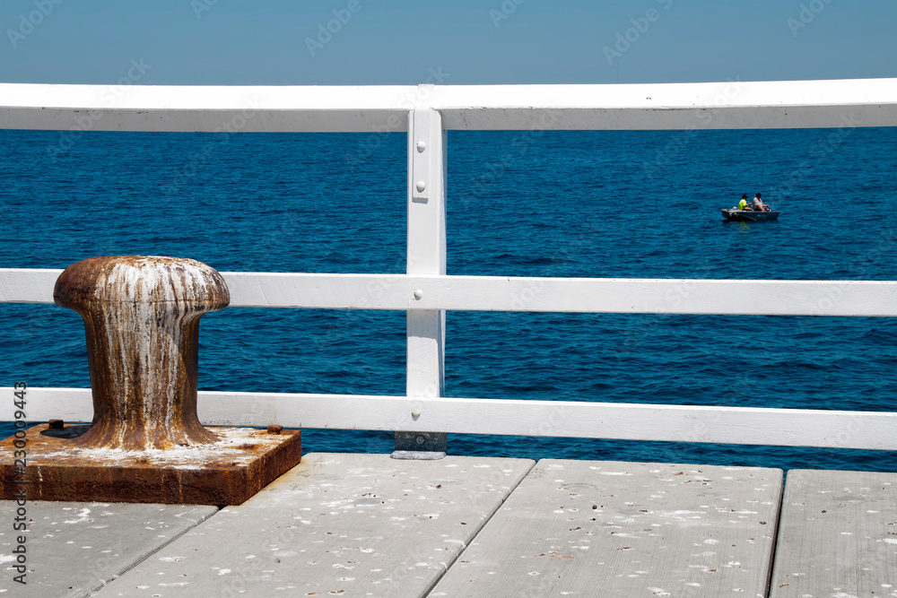 Busselton Australia, view of fishermen in dingy from jetty Busselton Australia, view of fishermen in dingy from jetty