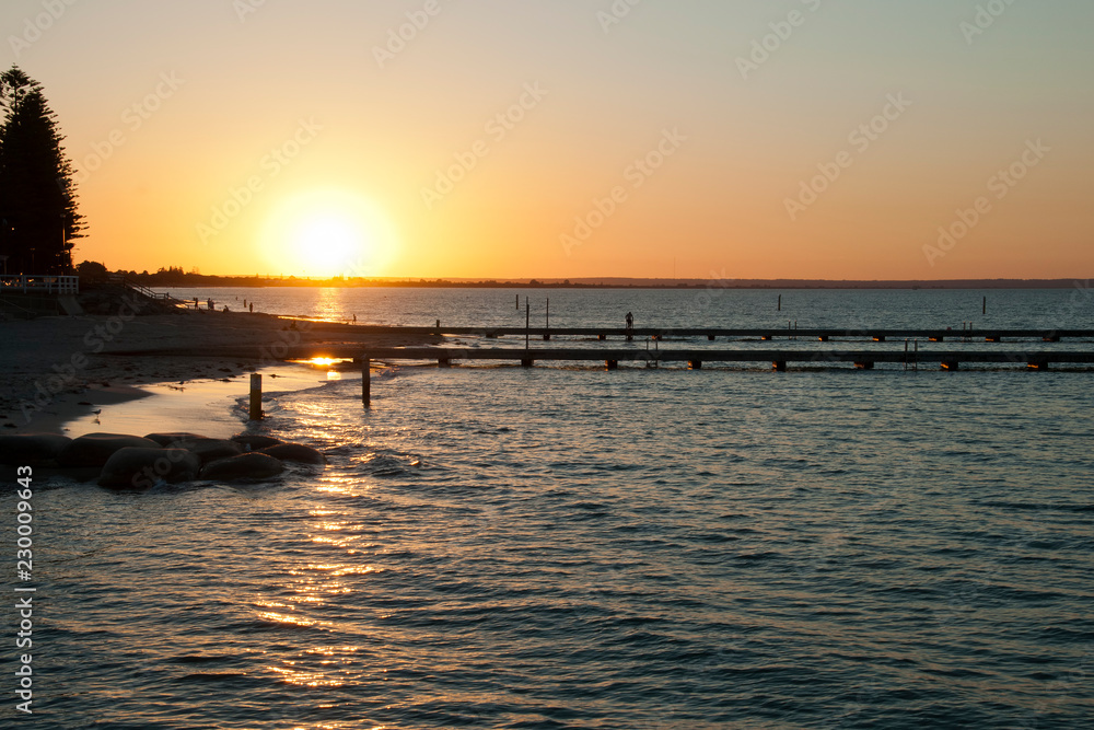 Busselton Australia, Sunset over Geographe Bay with ocean bathes in foreground