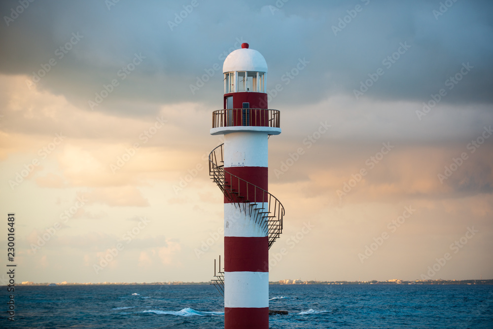Red and White Lighthouse at sea