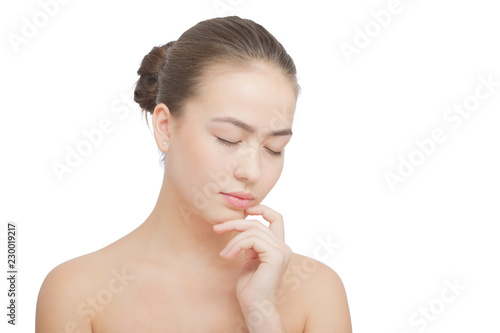 sad beautiful girl looking down on white background with copy space