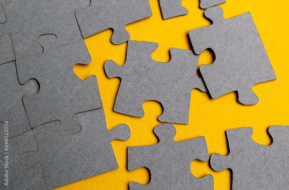 Obraz premium Texture puzzles gray on a yellow background