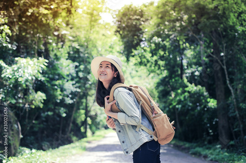 Happy young woman with a backpack, She is happy to have a wild adventure in forest nature and fresh air.