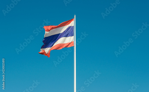 Image of waving Thailand flag with clear blue sky.