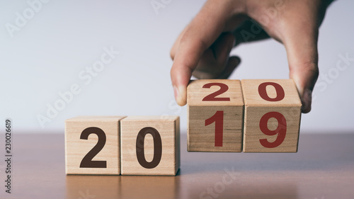 New year 2019 change to 2020 concept, hand change wooden cubes