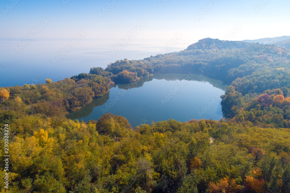 Picturesque mountain lake in autumn. Lake near the sea. Beautiful wild nature. Aerial view