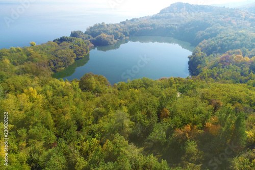 Picturesque mountain forest lake in autumn. Lake near the sea. Beautiful wild nature. Aerial view
