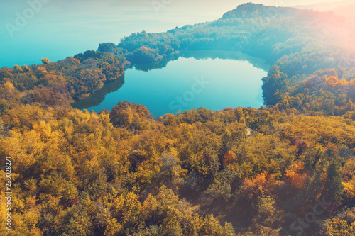 Picturesque mountain forest lake in autumn at sunrise. Lake near the sea. Beautiful wild nature. Aerial view