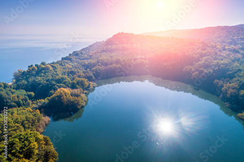 Picturesque mountain lake in autumn at sunrise. Lake near the sea. Beautiful wild nature. Aerial view