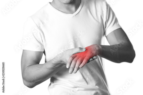 A man holding hands. Pain in the wrist. The hearth is highlighted in red. Close up. Isolated on white background