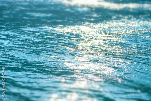 Blur tropical summer sea with bokeh sunlight wave abstract background. Abstract bokeh background of summer blue sea water surface
