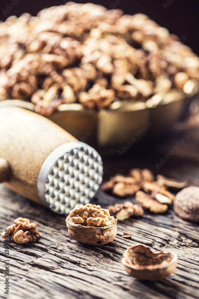 Walnut kernels whole walnuts in burlap sack and vintage bowl