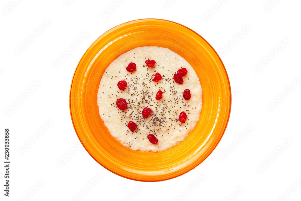 Top view orange bowl of semolina sweet porridge with chia seeds and dried berries isolated at white background. Concept of healthy lifestyle.