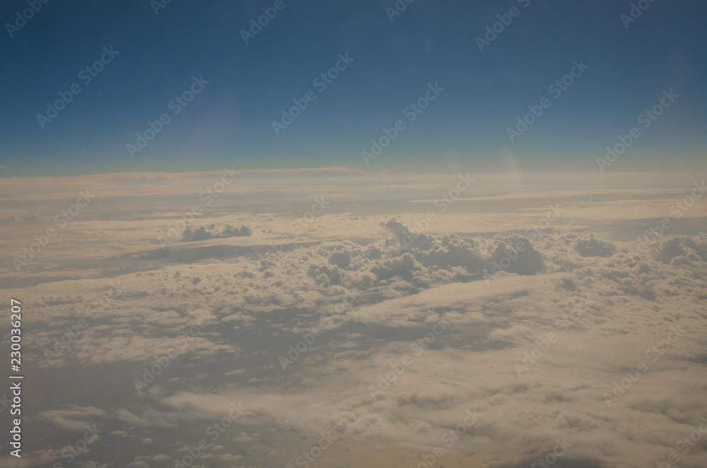 Picture of airplane wing, cloudy sky from porthole Picture of airplane wing, cloudy sky from porthole