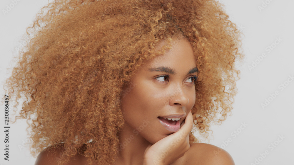 mixed race black blonde model with curly hair wondered model turned face to  the right Stock Photo | Adobe Stock