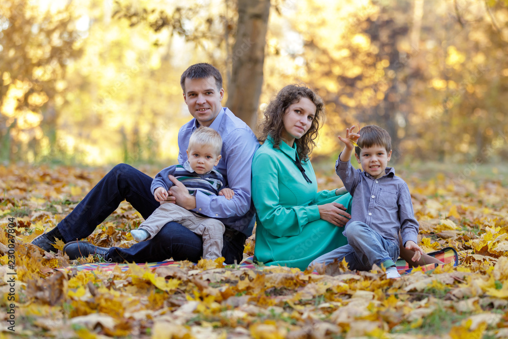 Group family portrait on the golden maple leaves. Early fall. Group family portrait on the golden maple leaves. Early fall.