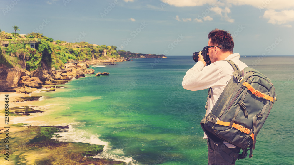 Active LifeStyle Travel photographer with camera in hand adventure on tropical island on background amazing nature landscape