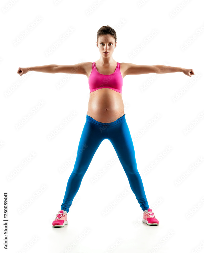 Pregnant woman doing yoga exercise on last months of pregnancy isolated on white background. Concept of healthy life