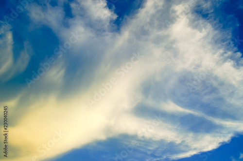 The movement of clouds in the sky on a windy day before sunset.