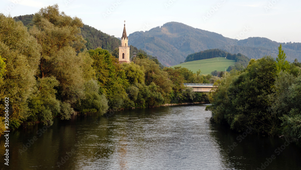 View of Mur river with church in Leoben,Austria