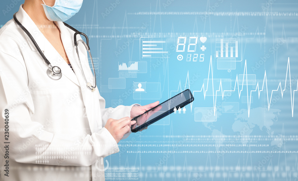 Female doctor holding tablet with blue background and heart related charts Female doctor holding tablet with blue background and heart related charts