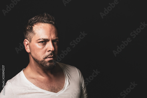 striking and expressive portrait of a male person looking into the camera with text space