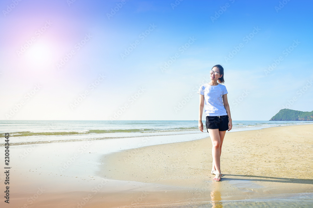 Beautiful women walking on the beach see blue sky and sea on background Beautiful women walking on the beach see blue sky and sea on background