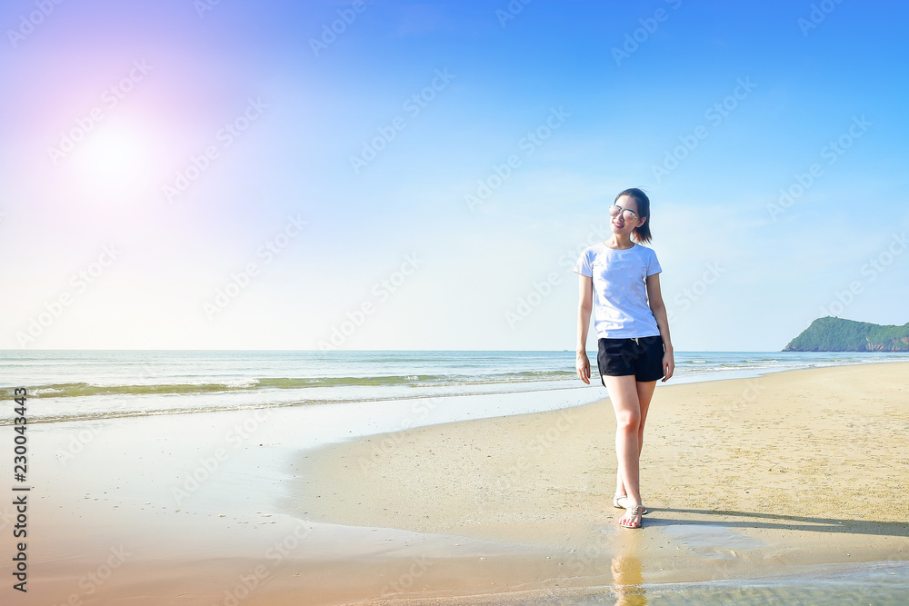 Beautiful women walking on the beach see blue sky and sea on background