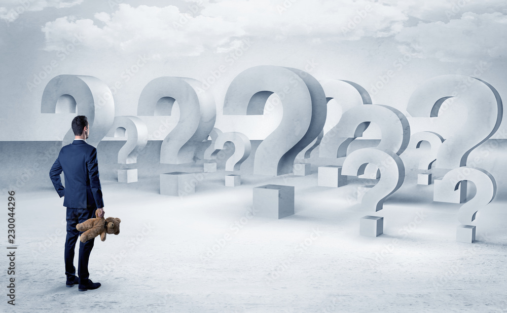 Businessman standing and looking to a bunch of question mark signs
Businessman standing and looking to a bunch of question mark signs