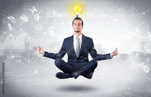 Businessman meditates with enlightenment data reports and financial concept 
