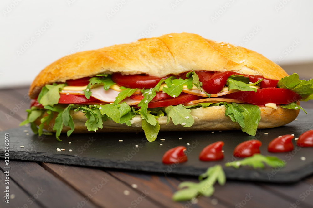 Sandwich with ham, cheese, tomatoes, sauce and salad Sandwich with ham, cheese, tomatoes, sauce and salad