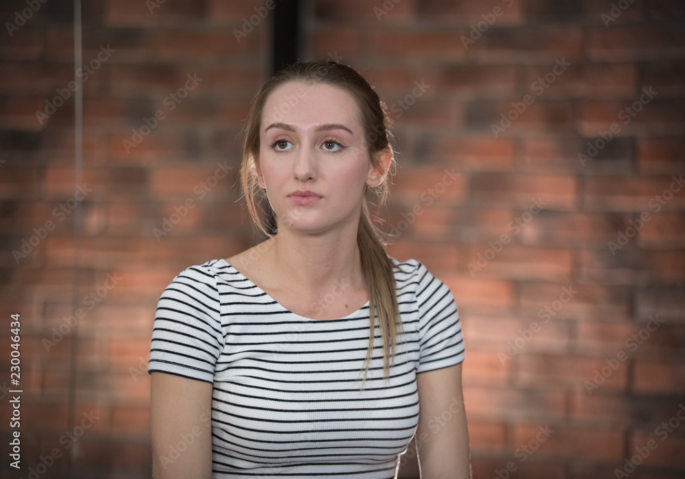 Young pretty woman in striped t-shirt looking away Young pretty woman in striped t-shirt looking away