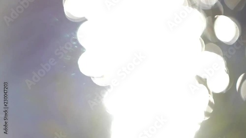 Roundels of sunlight formed an abstract moving pattern on the waves of the lake